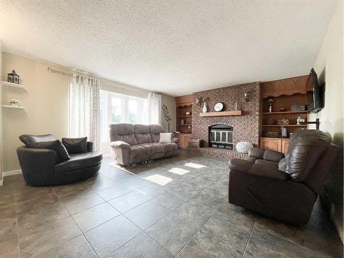 4900 2Nd Avenue North, Chauvin, AB - Indoor Photo Showing Living Room With Fireplace