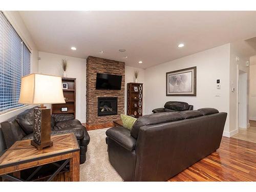 1605 53A Avenue Close, Lloydminster, AB - Indoor Photo Showing Living Room With Fireplace