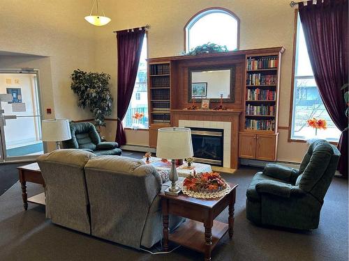 103-5120 51 Avenue, Vermilion, AB - Indoor Photo Showing Living Room With Fireplace