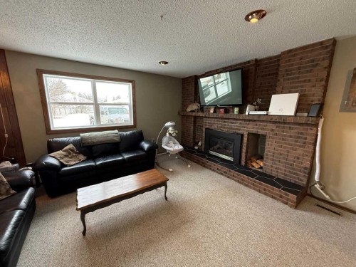 4606 50 Avenue, Vermilion, AB - Indoor Photo Showing Living Room With Fireplace