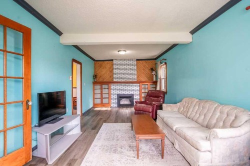 4716 52 Avenue, Vermilion, AB - Indoor Photo Showing Living Room With Fireplace