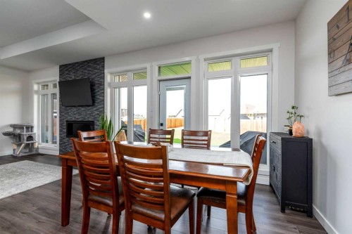 7302 37 Street Close, Lloydminster, AB - Indoor Photo Showing Dining Room With Fireplace