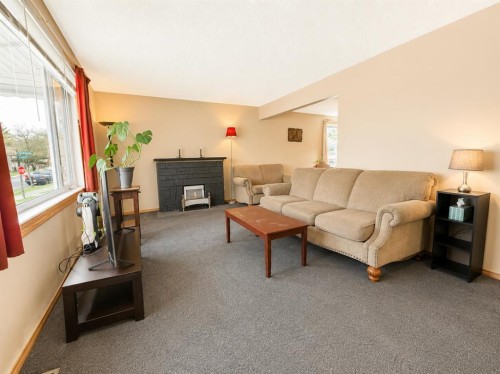 614 6 Avenue, Wainwright, AB - Indoor Photo Showing Living Room With Fireplace