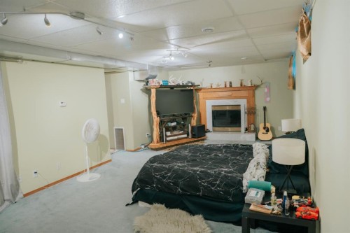 517 22 Street, Wainwright, AB - Indoor Photo Showing Bedroom With Fireplace
