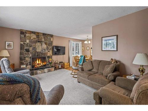 17 Barrier Mountain Drive, Exshaw, AB - Indoor Photo Showing Living Room With Fireplace