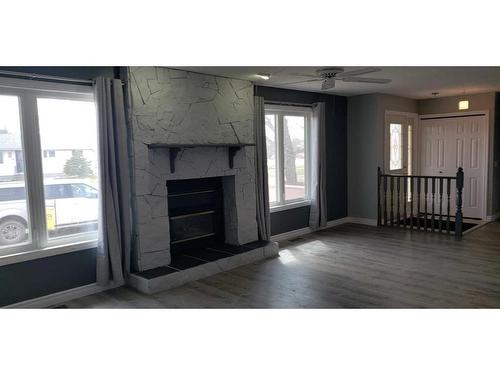 213 2 Avenue South, Champion, AB - Indoor Photo Showing Living Room With Fireplace