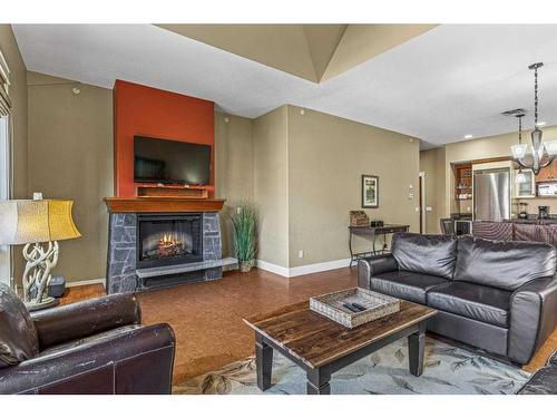407-187 Kananaskis Way, Canmore, AB - Indoor Photo Showing Living Room With Fireplace