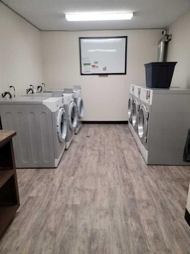 209-1712 38 Street Se, Calgary, AB - Indoor Photo Showing Laundry Room