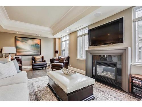 308-600 Princeton Way Sw, Calgary, AB - Indoor Photo Showing Living Room With Fireplace