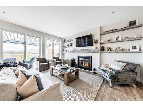 150 Riviera View, Cochrane, AB - Indoor Photo Showing Living Room With Fireplace