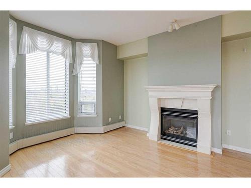 509-1718 14 Avenue Nw, Calgary, AB - Indoor Photo Showing Living Room With Fireplace