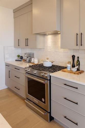 112 Sunrise Heath, Cochrane, AB - Indoor Photo Showing Kitchen With Upgraded Kitchen