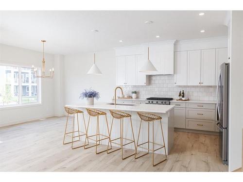 47 Sundown Crescent, Cochrane, AB - Indoor Photo Showing Kitchen With Upgraded Kitchen
