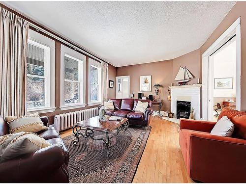 725 Macleod Trail Sw, High River, AB - Indoor Photo Showing Living Room With Fireplace