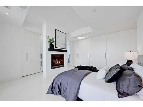 707-1020 9 Avenue Se, Calgary, AB - Indoor Photo Showing Bedroom With Fireplace