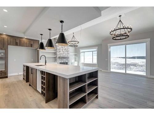13 Sunvalley View, Cochrane, AB - Indoor Photo Showing Kitchen With Fireplace