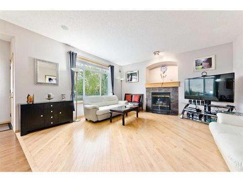 140 West Creek Glen, Chestermere, AB - Indoor Photo Showing Living Room With Fireplace