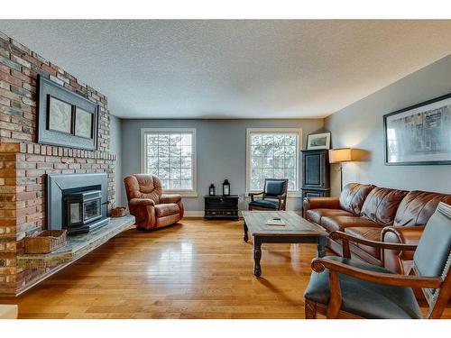 5128 Baines Road Nw, Calgary, AB - Indoor Photo Showing Living Room With Fireplace