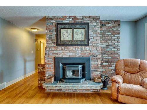 5128 Baines Road Nw, Calgary, AB - Indoor Photo Showing Living Room With Fireplace