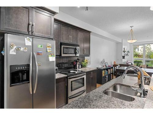 102-41 6A Street Ne, Calgary, AB - Indoor Photo Showing Kitchen With Stainless Steel Kitchen With Double Sink