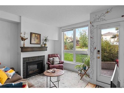 102-41 6A Street Ne, Calgary, AB - Indoor Photo Showing Living Room With Fireplace