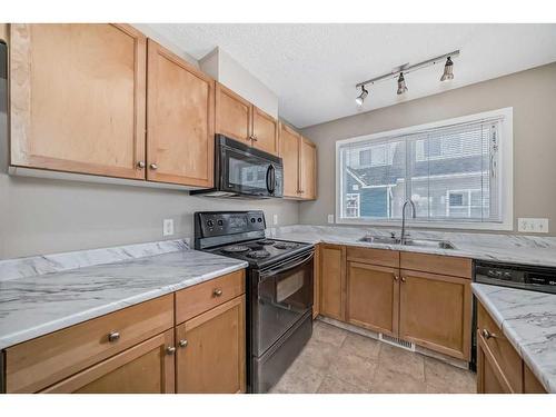 156 Promenade Way Se, Calgary, AB - Indoor Photo Showing Kitchen With Double Sink