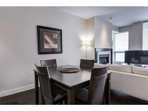 1112-222 Riverfront Avenue Sw, Calgary, AB - Indoor Photo Showing Dining Room With Fireplace