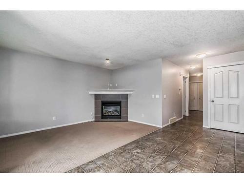 29 Saddlecrest Green Ne, Calgary, AB - Indoor Photo Showing Living Room With Fireplace