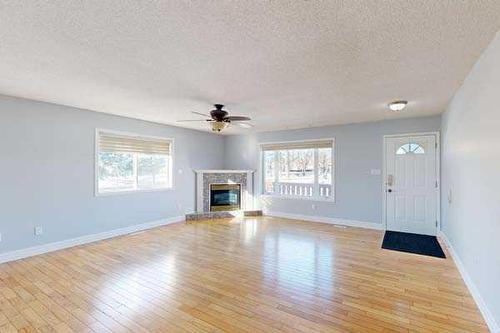 221 49 Avenue West, Claresholm, AB - Indoor Photo Showing Living Room With Fireplace