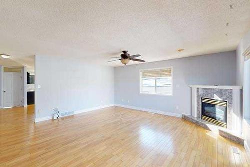 221 49 Avenue West, Claresholm, AB - Indoor Photo Showing Other Room With Fireplace
