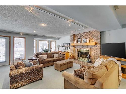 99 Hampshire Close Nw, Calgary, AB - Indoor Photo Showing Living Room With Fireplace