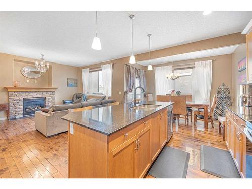 8 Sunset View, Cochrane, AB - Indoor Photo Showing Kitchen With Fireplace