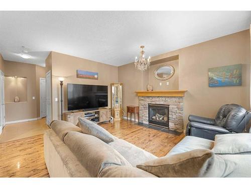8 Sunset View, Cochrane, AB - Indoor Photo Showing Living Room With Fireplace
