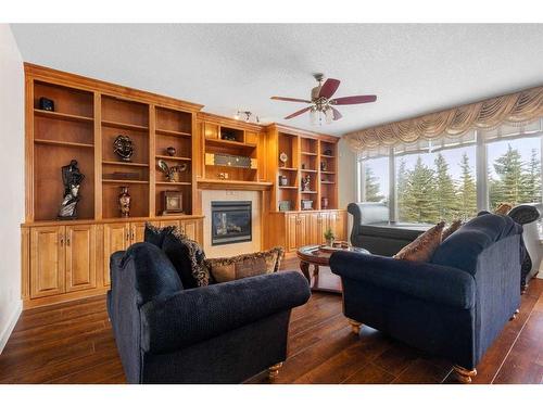 32 Lynx Ridge Boulevard Nw, Calgary, AB - Indoor Photo Showing Living Room With Fireplace