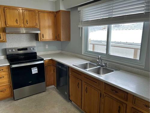 2201 22 Street, Nanton, AB - Indoor Photo Showing Kitchen With Double Sink