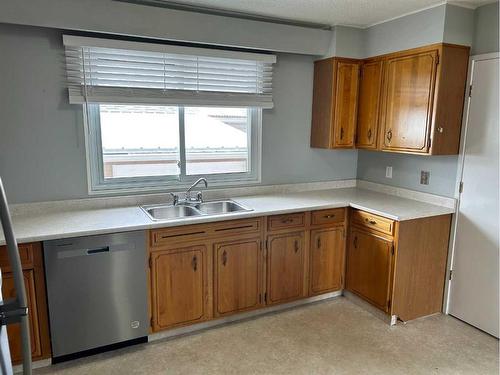 2201 22 Street, Nanton, AB - Indoor Photo Showing Kitchen With Double Sink