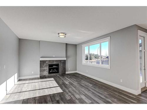 1213 Coopers Drive Sw, Airdrie, AB - Indoor Photo Showing Living Room With Fireplace