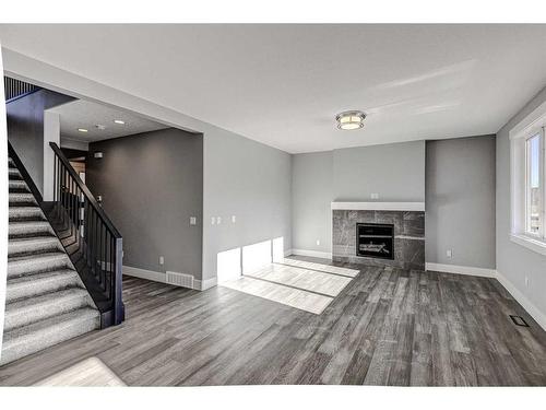 1213 Coopers Drive Sw, Airdrie, AB - Indoor With Fireplace