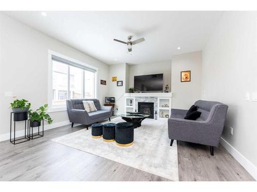 162 Kinniburgh Crescent, Chestermere, AB - Indoor Photo Showing Living Room With Fireplace