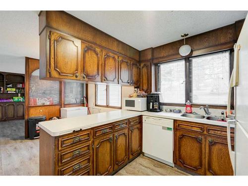 450 Muskrat Street, Banff, AB - Indoor Photo Showing Kitchen With Double Sink