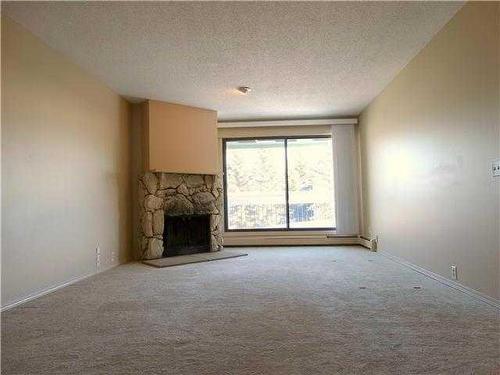 135-10120 Brookpark Boulevard Sw, Calgary, AB - Indoor With Fireplace
