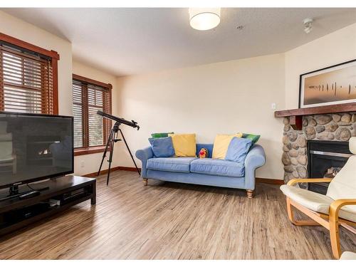 319-170 Crossbow Place, Canmore, AB - Indoor Photo Showing Living Room With Fireplace