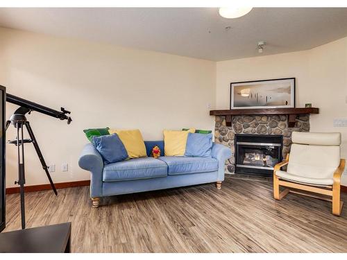 319-170 Crossbow Place, Canmore, AB - Indoor Photo Showing Living Room With Fireplace