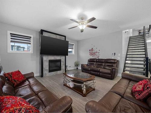 441 Kinniburgh Cove, Chestermere, AB - Indoor Photo Showing Living Room With Fireplace