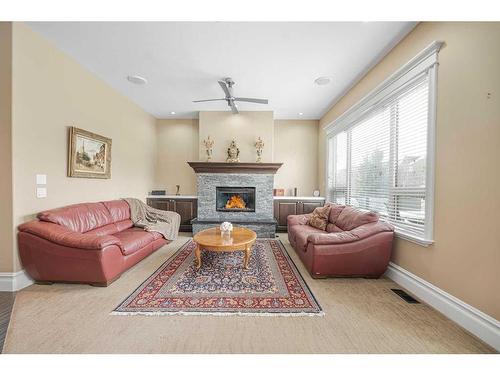 235 Coopers Hill Sw, Airdrie, AB - Indoor Photo Showing Living Room With Fireplace