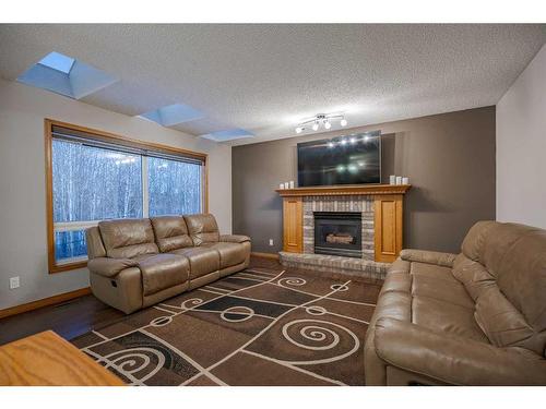 30 Rocky Ridge Landing Nw, Calgary, AB - Indoor Photo Showing Living Room With Fireplace