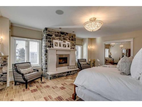 44 Aspen Ridge Heights Sw, Calgary, AB - Indoor Photo Showing Bedroom With Fireplace
