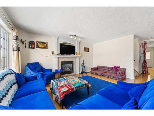411 Taralake Way Ne, Calgary, AB - Indoor Photo Showing Living Room With Fireplace