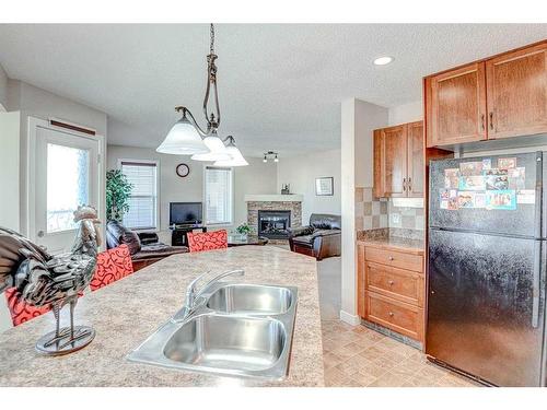 274 Covecreek Close Ne, Calgary, AB - Indoor Photo Showing Kitchen With Fireplace With Double Sink