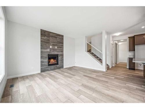 516 Northern Lights Place, Langdon, AB - Indoor Photo Showing Living Room With Fireplace